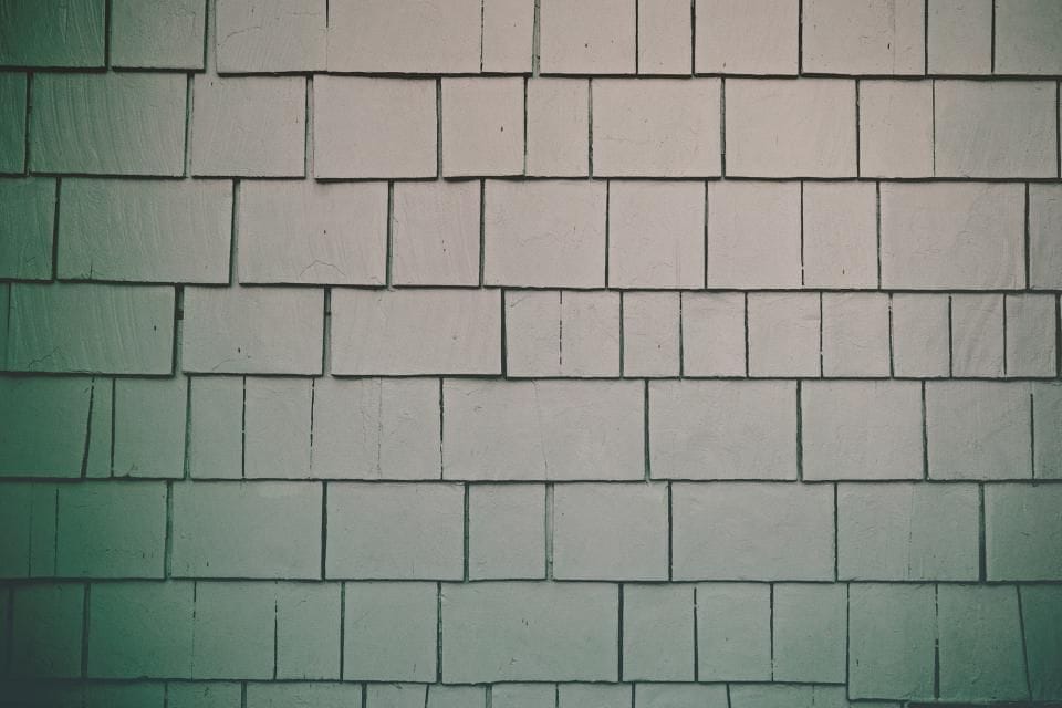 Rows of glossy green tiles on a wall