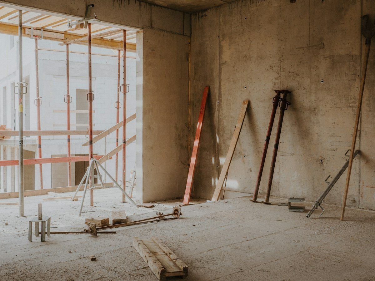 An interior under renovation, scaffolding against bare plaster walls