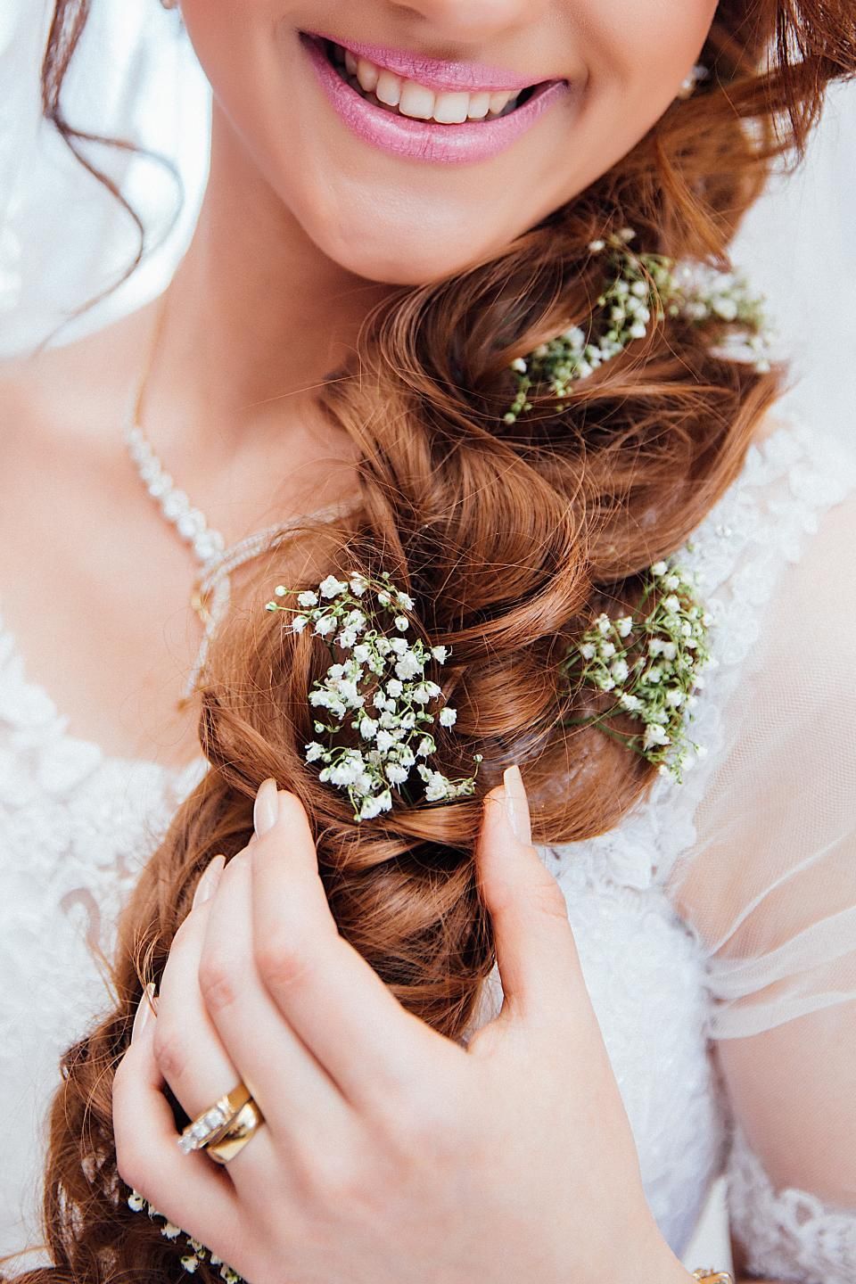 Baby's breath woven into a bride's braid