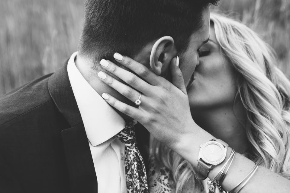A couple kissing in black and white