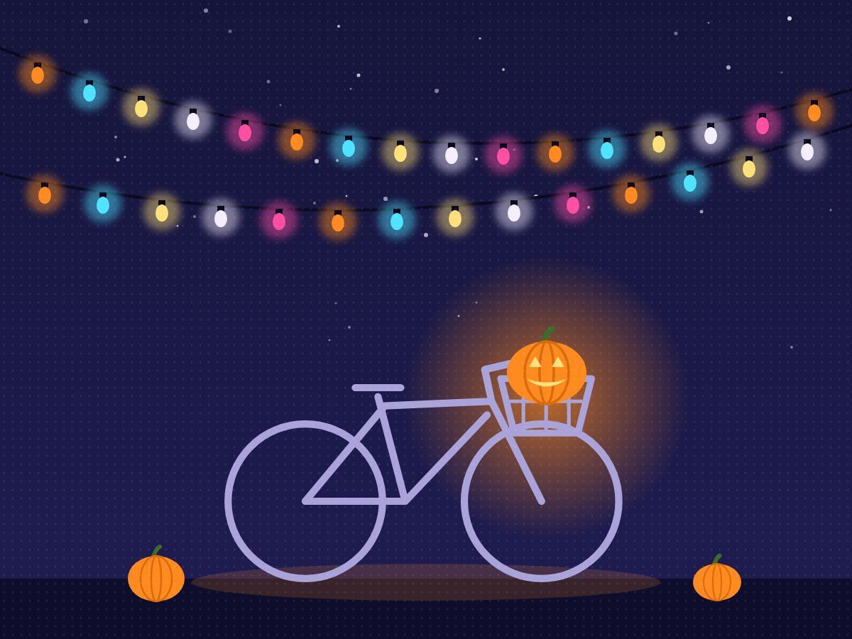 A bike with a pumpkin lantern under string lights