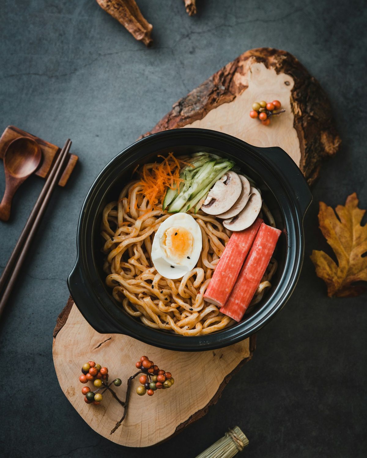 A bowl of ramen with an egg on a dark slate
