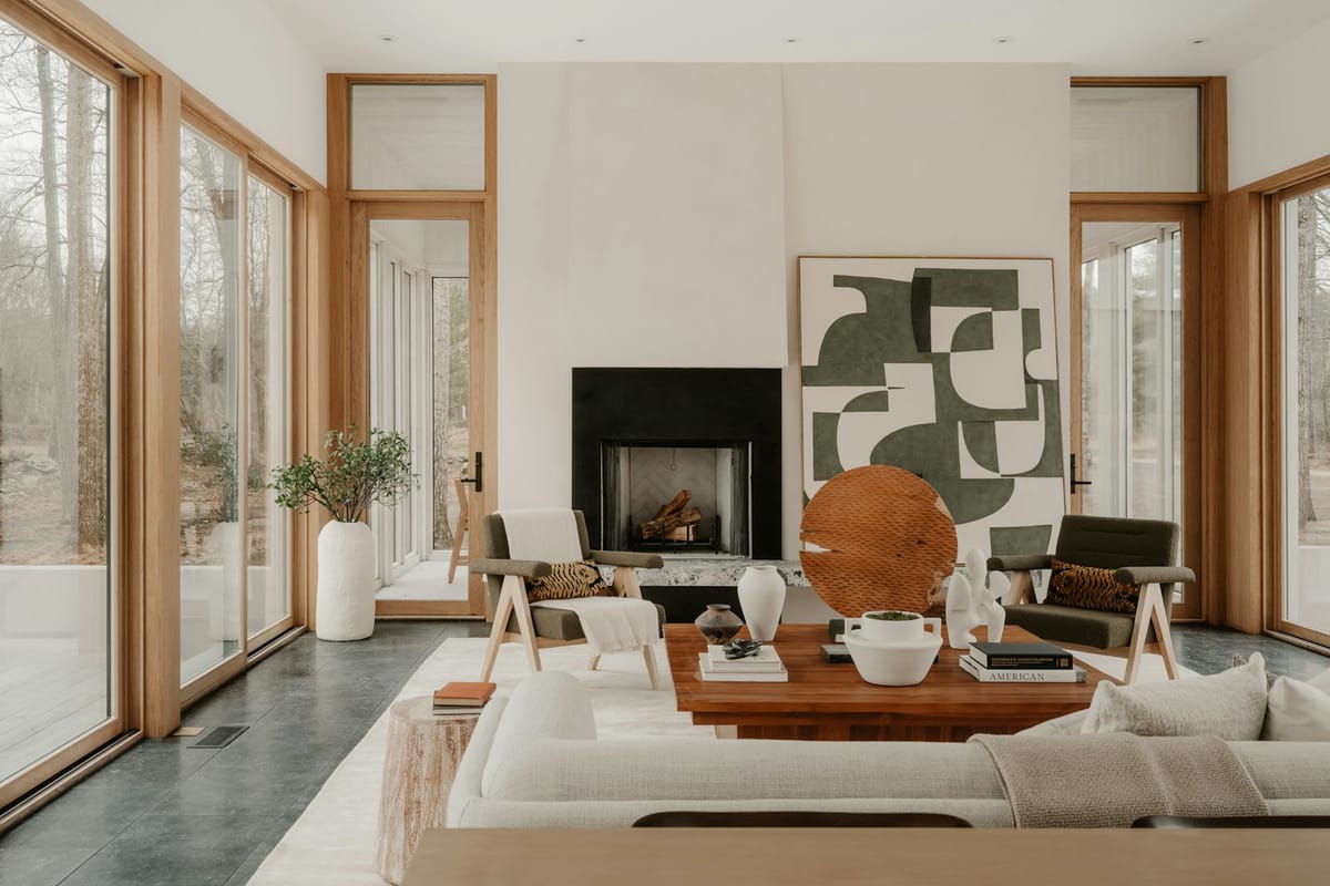 A bright living room with a fireplace and tall windows