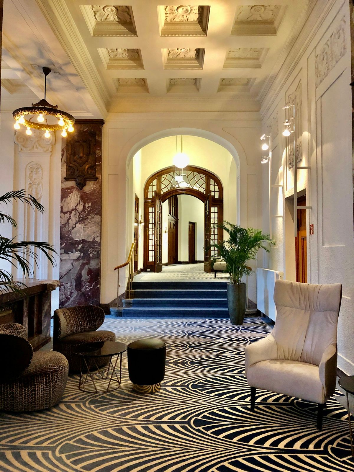 A hotel lobby with a zebra-striped rug and an arched doorway