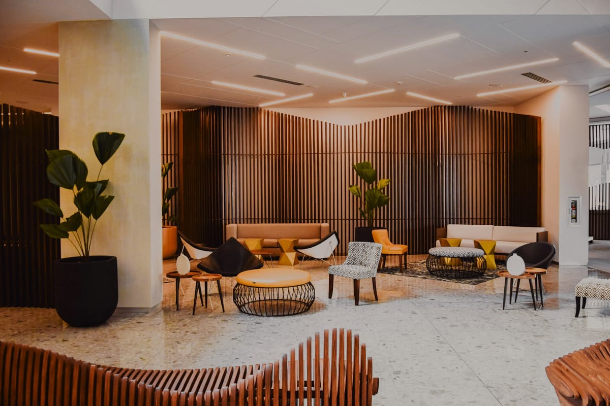 A hotel lounge with timber slats and warm seating