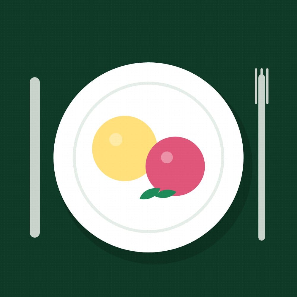A white plate with a yellow and a pink circle on dark green